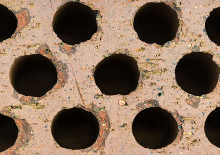 An abstract macro shot of the holes in top of a brick.の写真素材