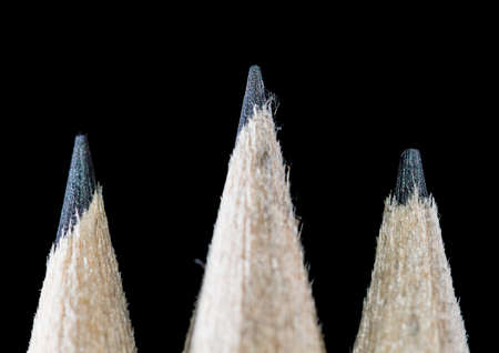 A macro shot of three pencils shot against a black background.の写真素材