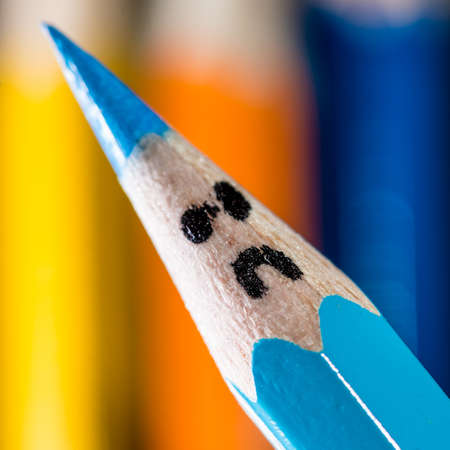 A fun macro shot of some coloured pencils with faces.の写真素材