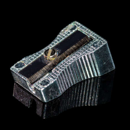 A macro shot of a pencil sharpener shot against a black background and showing a reflection.の写真素材