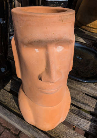 A terracotta pot fashioned as a Moai head.の写真素材