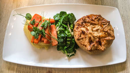 A close-up shot of a plate of pie and mash.の写真素材