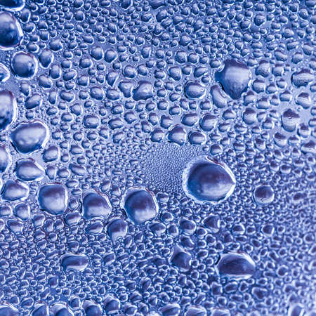 An abstract macro shot of condensation formed on the inside of a car headlight.の写真素材