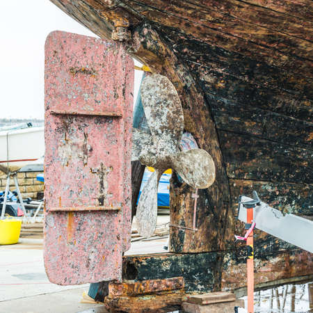 A shot of a propeller and rudder from a boat undergoing restoration work at Hartlepool marina, UK.の写真素材