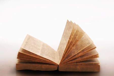 grungy old open book isolated on white の写真素材