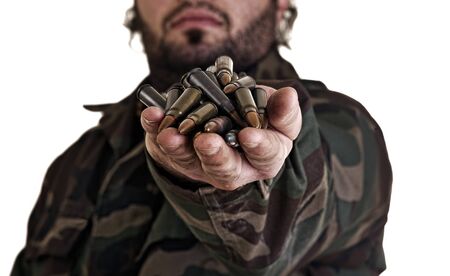Grungy mood of a warrior in the army holding bullets