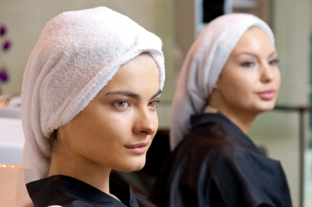 beautiful woman with towel on her head after washing her hair の写真素材