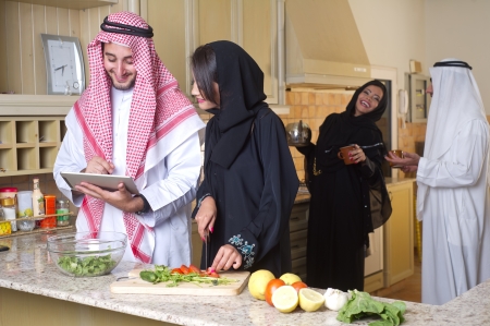 arabian couples gathering cooking   drinking coffee in kitchen の写真素材