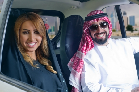 arabian couple in a newely purchased car enjoying life 