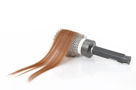 Close-up of a hairbrush with hair in it isolated on white  の写真素材