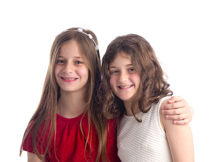Two Beautiful Sisters hugging isolated on white の写真素材
