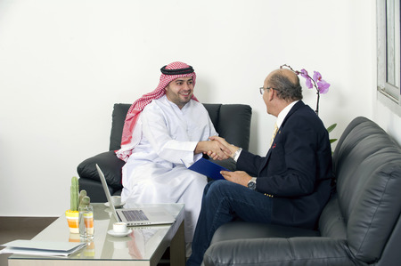 Senior Businessman Shaking hands with Arabian Businessmanの写真素材