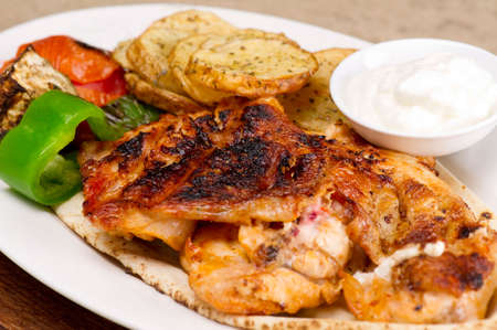 Grilled chicken fillets, with potatoes and vegetables and mayo garlic dip