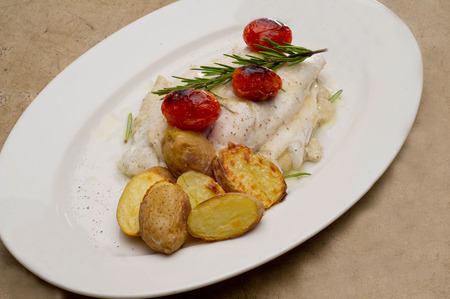 Fish dish - fish fillet in sauce and vegetablesの写真素材