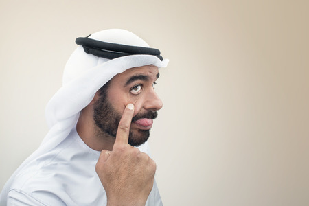 Arabian man doing a funny expression , Clumsy expression of an Arabian businessmanの写真素材