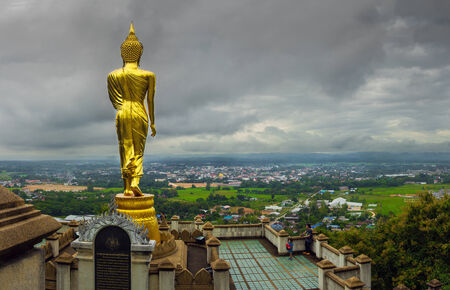 Nan province, Thailand : 24 Oct 2014 Golden walking Buddha image located in wat prabat khao noi (temple)のeditorial素材