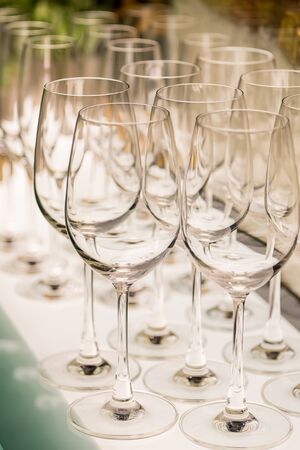 Closeup of wine glasses on illuminated barの写真素材