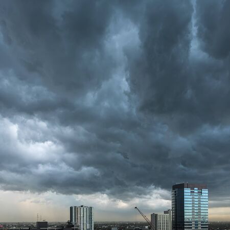 A sky background with dark clouds of storm in rainy season.の写真素材
