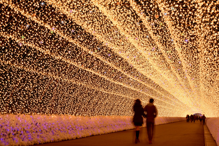 Mie, Japan - March 4, 2015: motion blur of unidentified tourist walk through light tunnel in Nabana no sato winter illumination ,Mie province. This is one of Japan's largest illumination parks.のeditorial素材