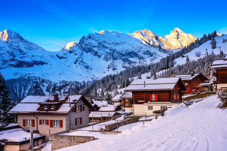 Murren, Switzerland - April 10, 2016 : Wood chalet in a car free mountain village 'Murren' in early morning with snow mountain and in background.のeditorial素材