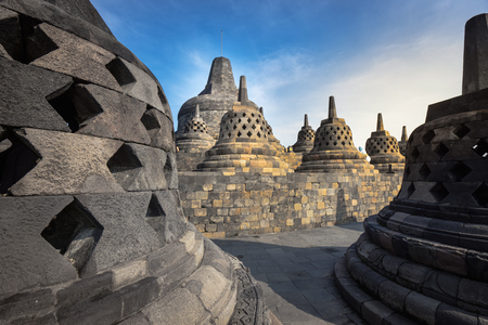 small stupa around top of Borobudor, world largest buddhist temple in Yogyakarta, Indonesia. Picture taken with the sunrise.の写真素材