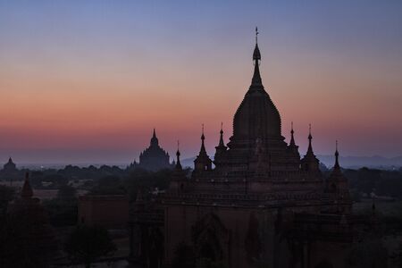 Silhouettes of old temples before sunrise in Bagan, Myanmarの写真素材