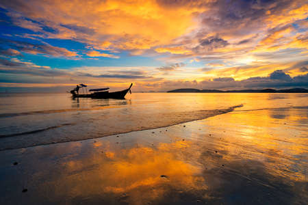 silhueate of tour boat with sunset sky background.