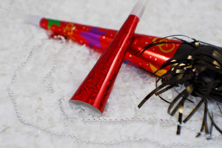 couple of new years eves horns sitting in the snowの写真素材