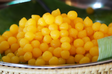 Tong yod, sweet egg yolk fudge balls cooked in syrup in banana leafの写真素材
