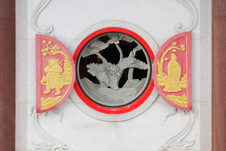 close-up gold color male and female marble carving wall, Decorative Chinese art style at Chinese public templeの写真素材