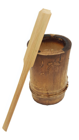 wooden bamboo cup pot with small wooden paddle isolated on white background, nature packaging style, charcoal basket for cooking steam rice and sticky rice dessertの写真素材