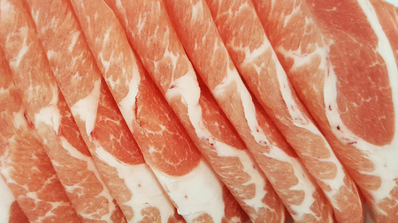 close-up sliced raw fresh meat on white plate for barbecue or shabu from fresh marketの写真素材