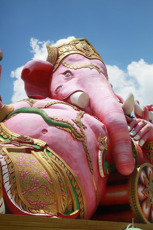 close-up ancient carving of clining peace Ganesha god, god of successful with blue clear sky backgroundの写真素材