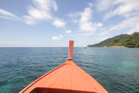 first person view of Wooden moving boat with Seascape and Clear Sky , perspective exploring the ocean, traditional long tail boat, commercial advertisementの写真素材