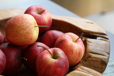 Group of organic fresh red apples on wooden tray, gourmet fruit shop, Healthy probiotic nutrition...