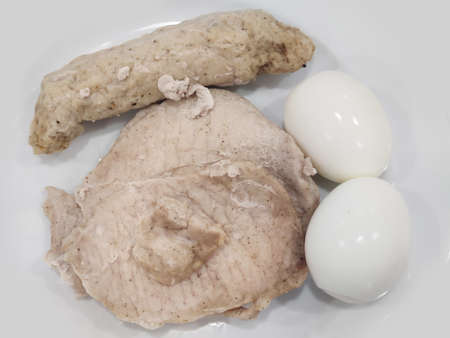 Pieces of healthy boiled fresh chicken pork breast serving on white plate, homemade restaurant, menu advertisement, food stylist backgroundsの写真素材