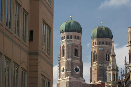 Both onion domes of the Gothic cathedral and city parish church known as the Frauenkirche, Dom zu unserer Lieben Frau, Cathedral of Our Dear Lady, travel destination backgrounds at Munich Germanyの写真素材