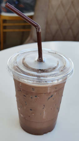 Freshness iced chocolate cafe latte in disposable take away cup with brown Straw, advsertising backgroundsの写真素材