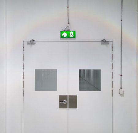Emergency exit door way with green exit light sign, clean area, walk path way in the GMP factoryの写真素材
