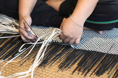 Close-up image of asian female hands tailor manual working sewing crafting at textile factory, advertisement backgroundsの写真素材