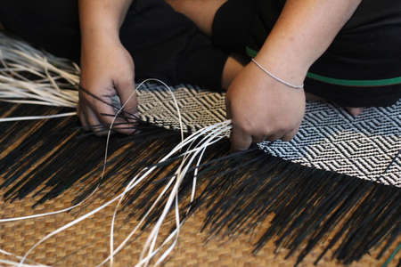 Close-up image of asian female hands tailor manual working sewing crafting at textile factory, advertisement backgroundsの写真素材