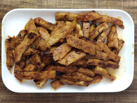 Sliced Grilled organic Chicken meat, pork, beef serving on white plate on wooden table, secret recipe restaurant, advertising menuの写真素材