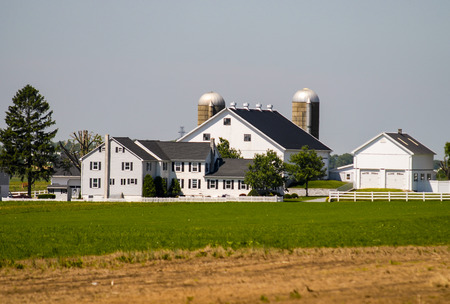 Amish Farm with White Fence on a Sunny Summer Dayの写真素材