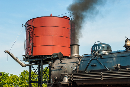 Steam Engine to get Water by Water Tower on a Sunny Day