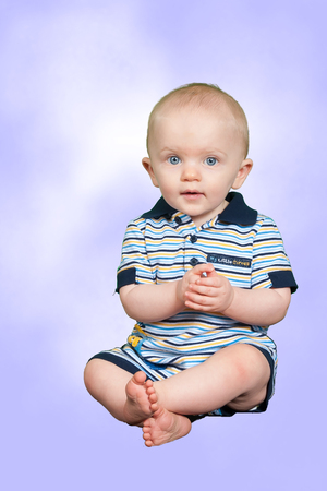 10 Month Old Happy Baby Boy on a Purple Backgroundの写真素材