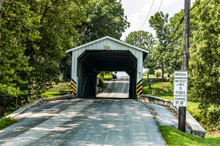Amish Covered Bridge Buggy Going Through It on a Summer Dayの写真素材