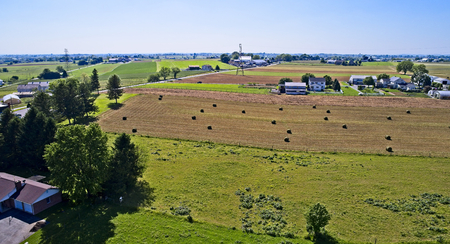 Aerial View of Amish Farmers Harvesting there Crops in Summerの写真素材