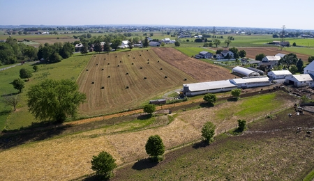 Aerial View of Amish Farmers Harvesting there Crops in Summerの写真素材