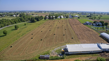 Aerial View of Amish Farmers Harvesting there Crops in Summerの写真素材