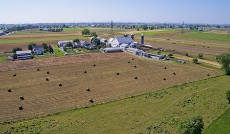 Aerial View of Amish Farmers Harvesting there Crops in Summerの写真素材